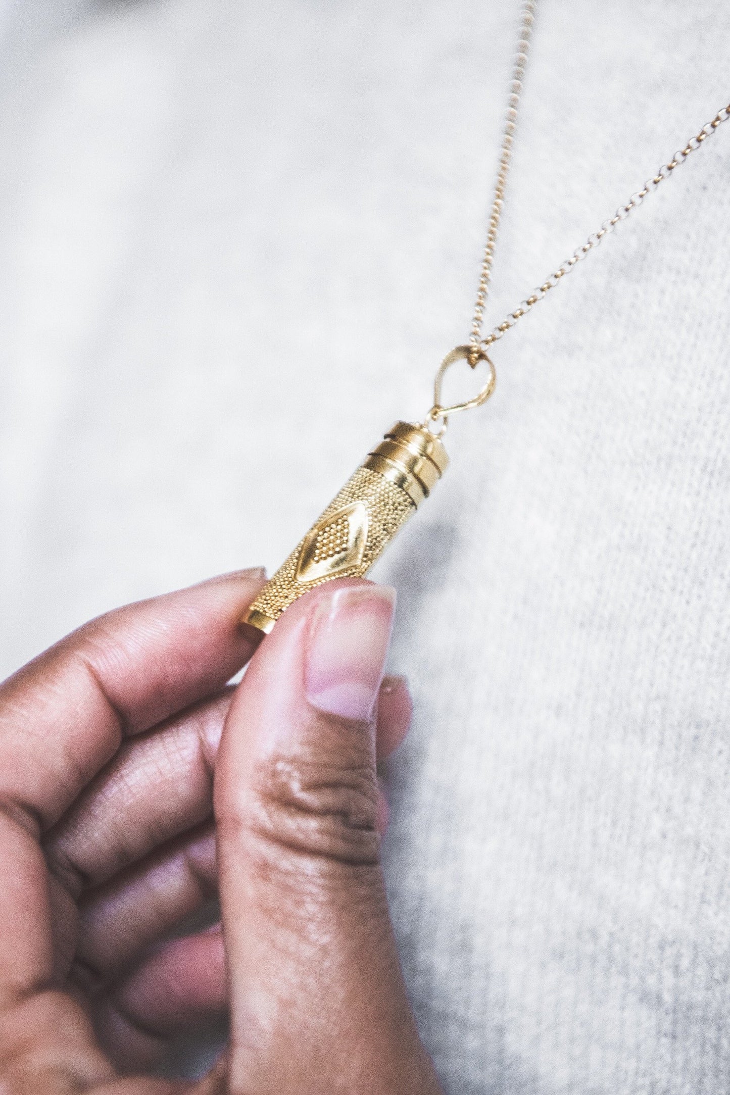 Close up of hand holding Eda Large Diamond Dot Wishing Locket