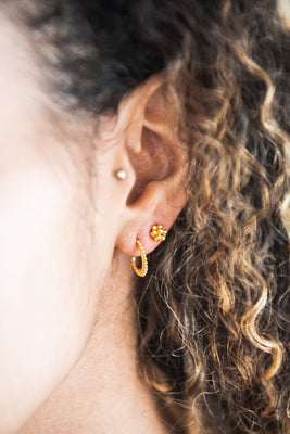 Close up of woman wearing Indira Hooped Stud earring