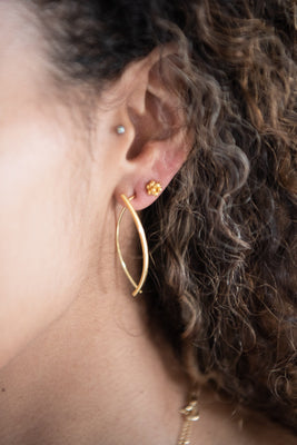 Close up of woman wearing Emmeline Curve Earring