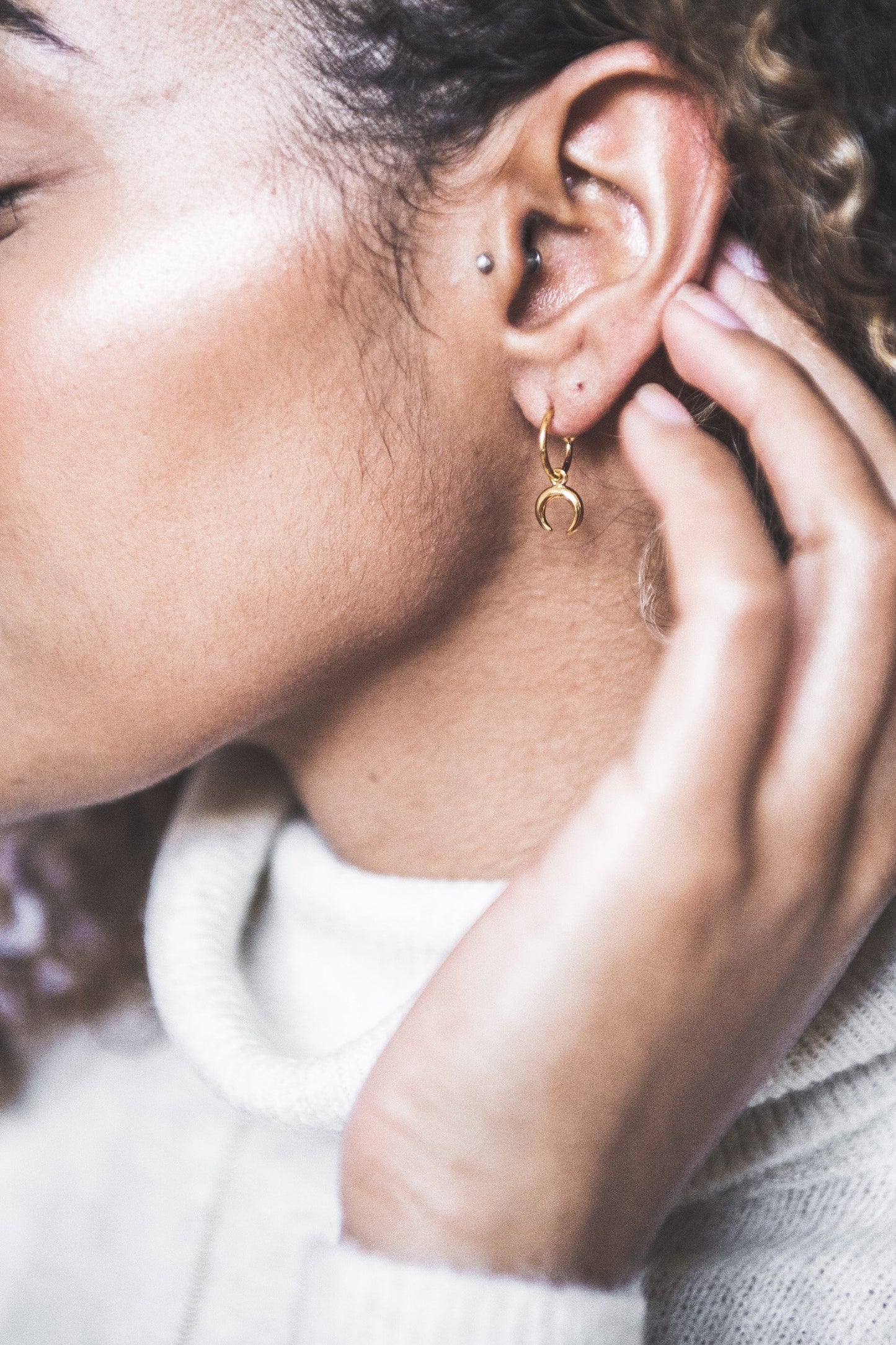 Close up of woman wearing Mini Crescent Hooped Stud earring