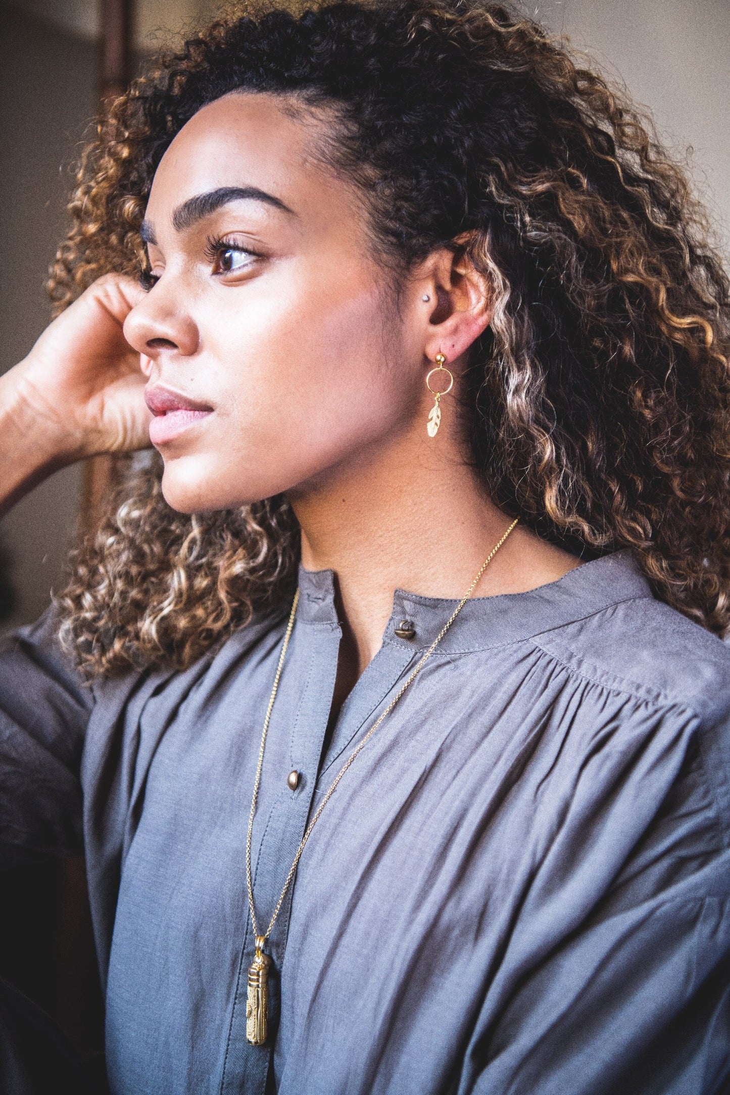 Woman wearing Mini Feather Hooped Stud earring