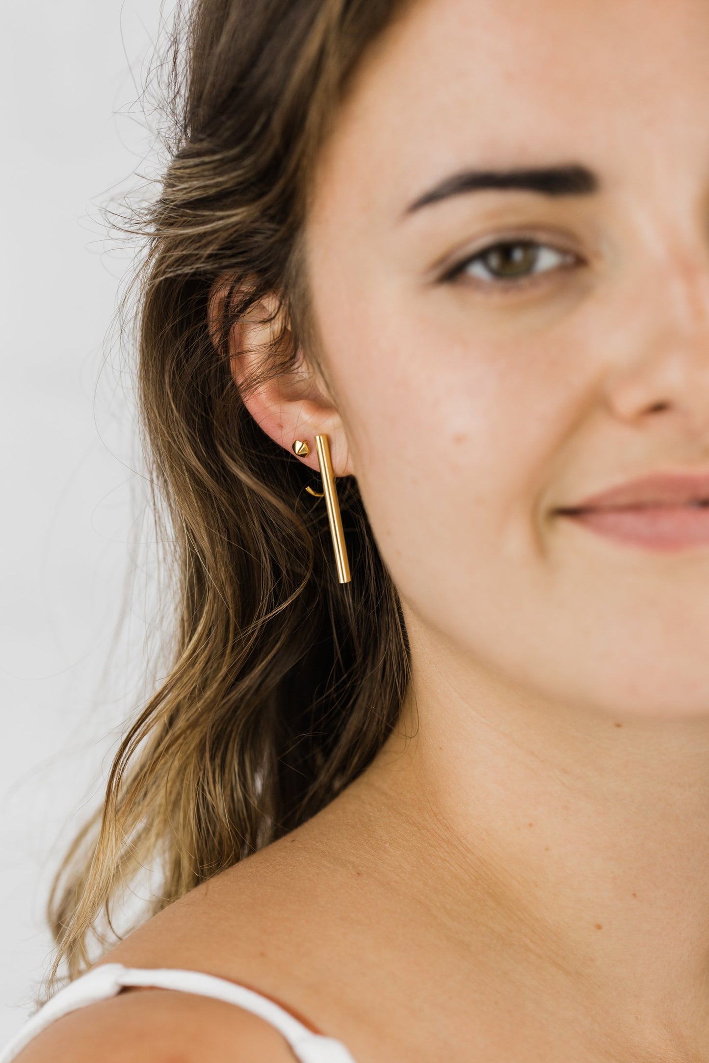 Close up of woman wearing Audrey Long Bar Stud earring