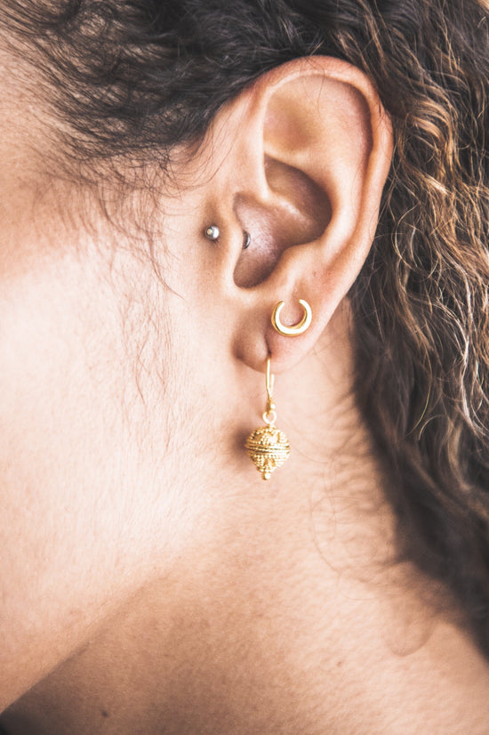 Close up of woman wearing Triangle Dot Harmony Ball Earring