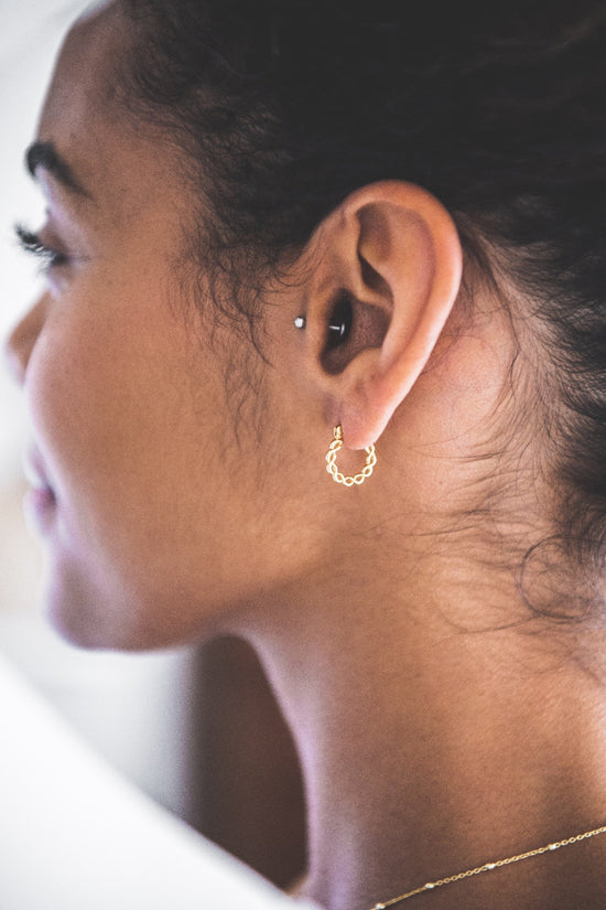 Close up of woman wearing Twisted Hoop earring