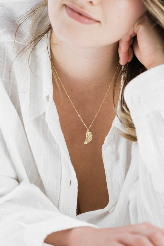 Woman wearing Angel Wing Satellite Chain Necklace