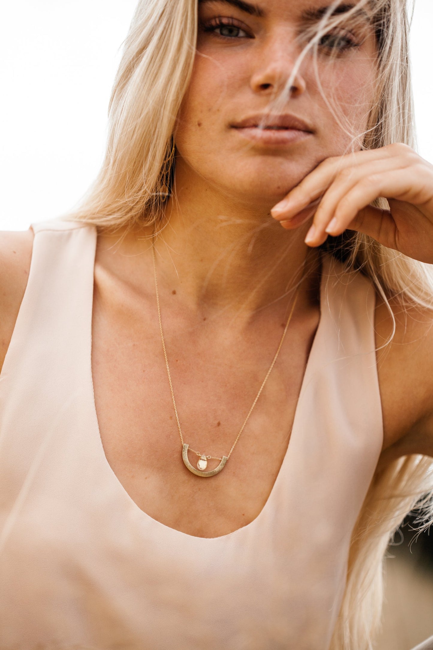 Woman wearing Guardian Crescent Clear Quartz Drop Necklace