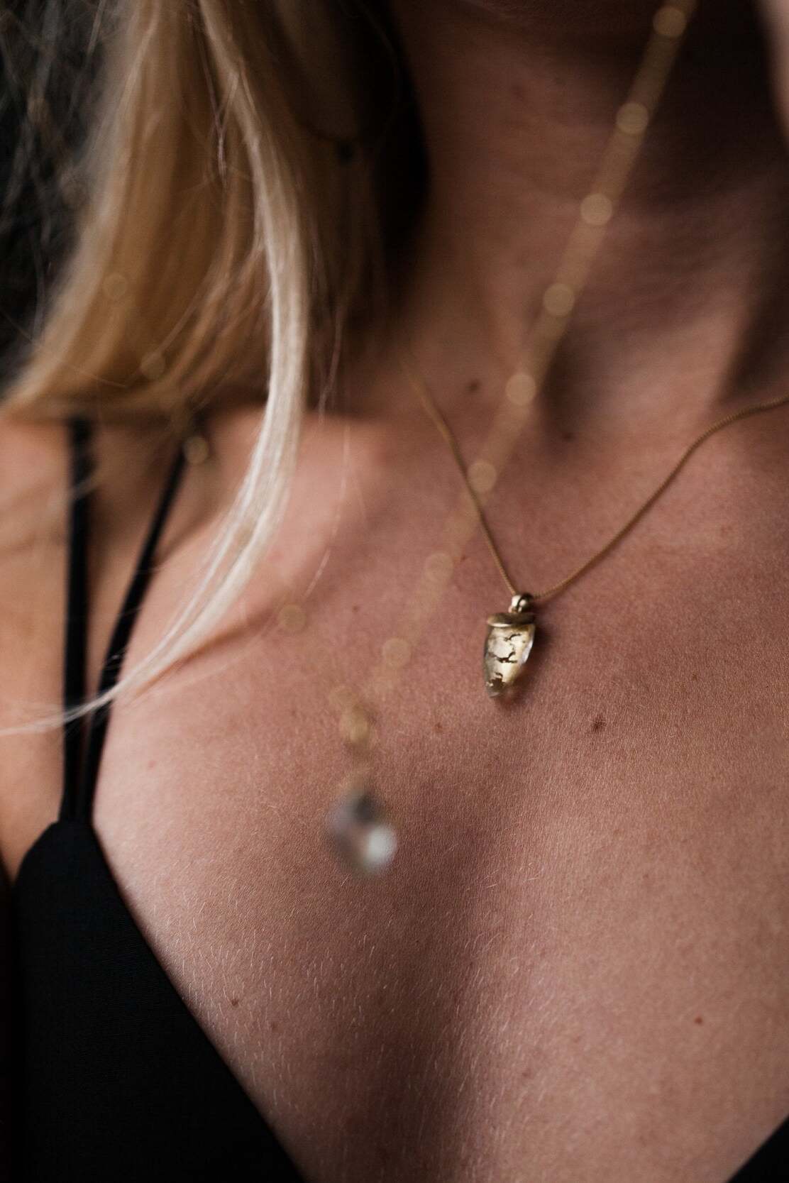 Woman wearing Guardian Clear Quartz Shield necklace