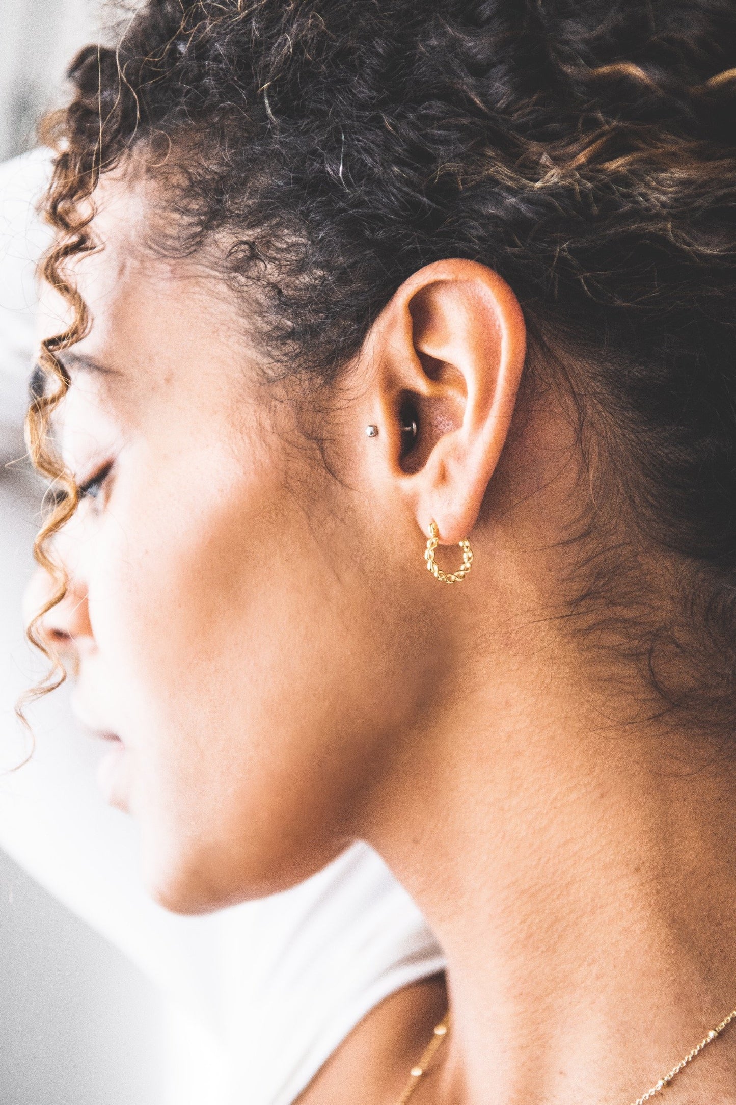 Woman wearing Twisted Hoop earring