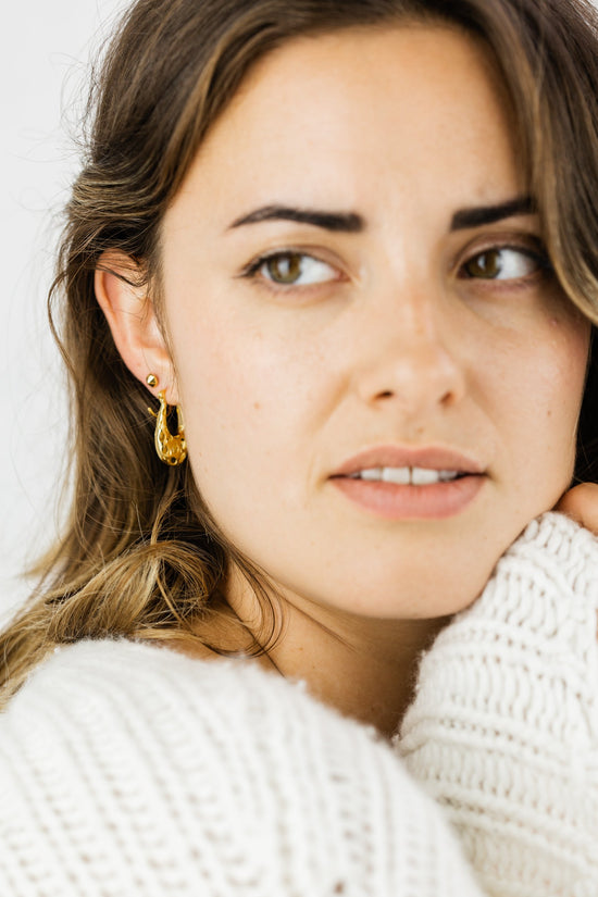 Close up of woman wearing Ella Open Oval Hoop earring