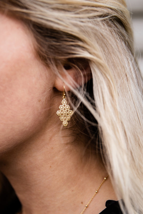 Close up of woman wearing Emmy Diamond Drop Flower Earring