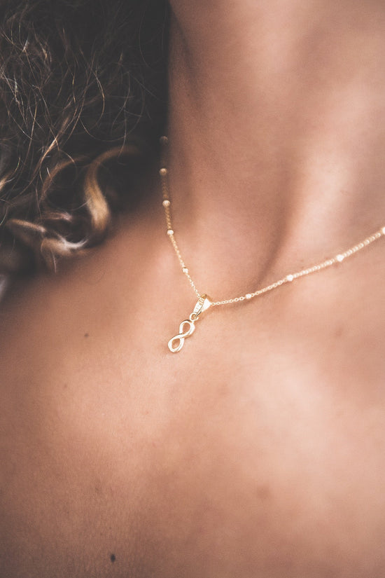 Close up of woman wearing Eternal Love Pendant Necklace