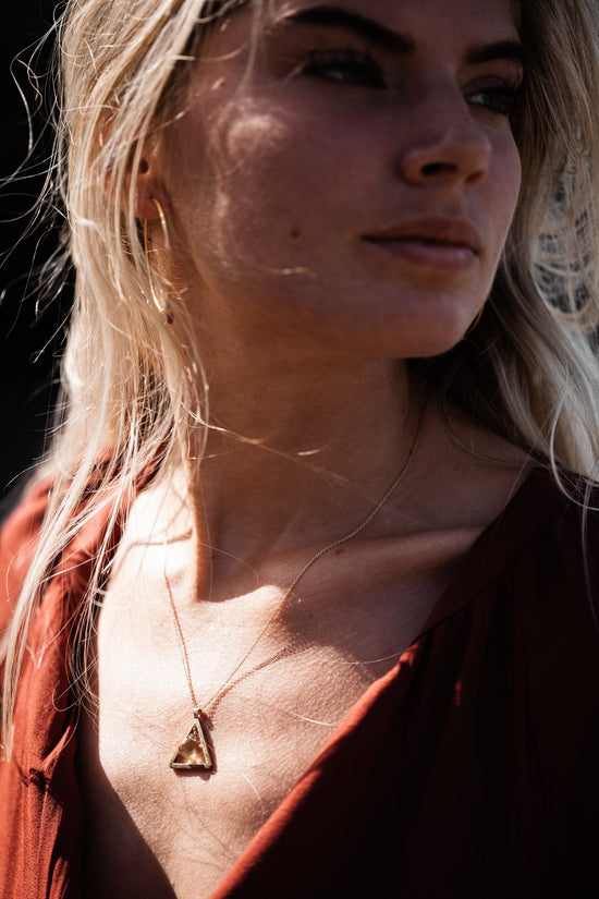 Close up of woman wearing Guardian Triangle Smokey Quartz Necklace 
