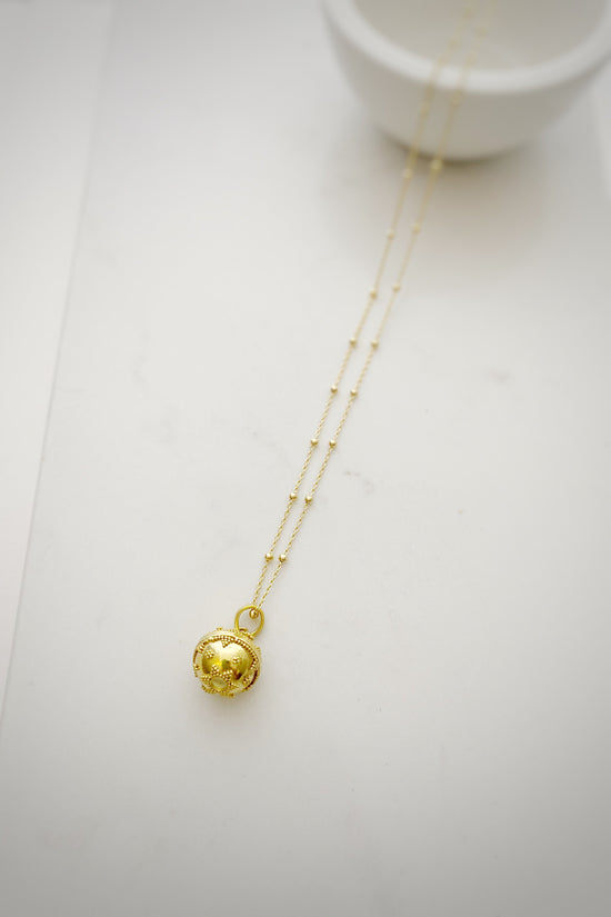Close up of Triangle Dot Design Harmony Ball necklace